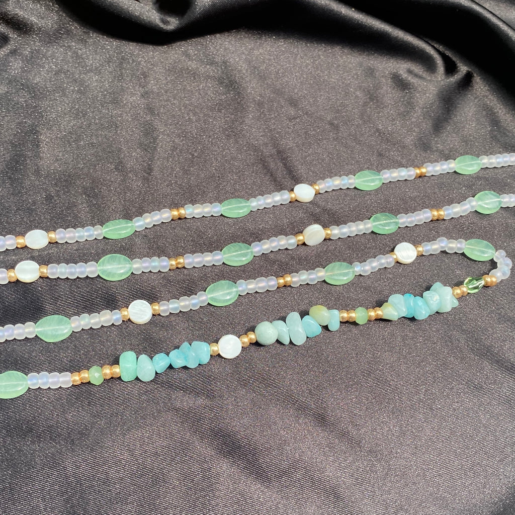 Transparent matte and gold waist beads made with sage green glass beads, white nacre beads and amazonite crystal.