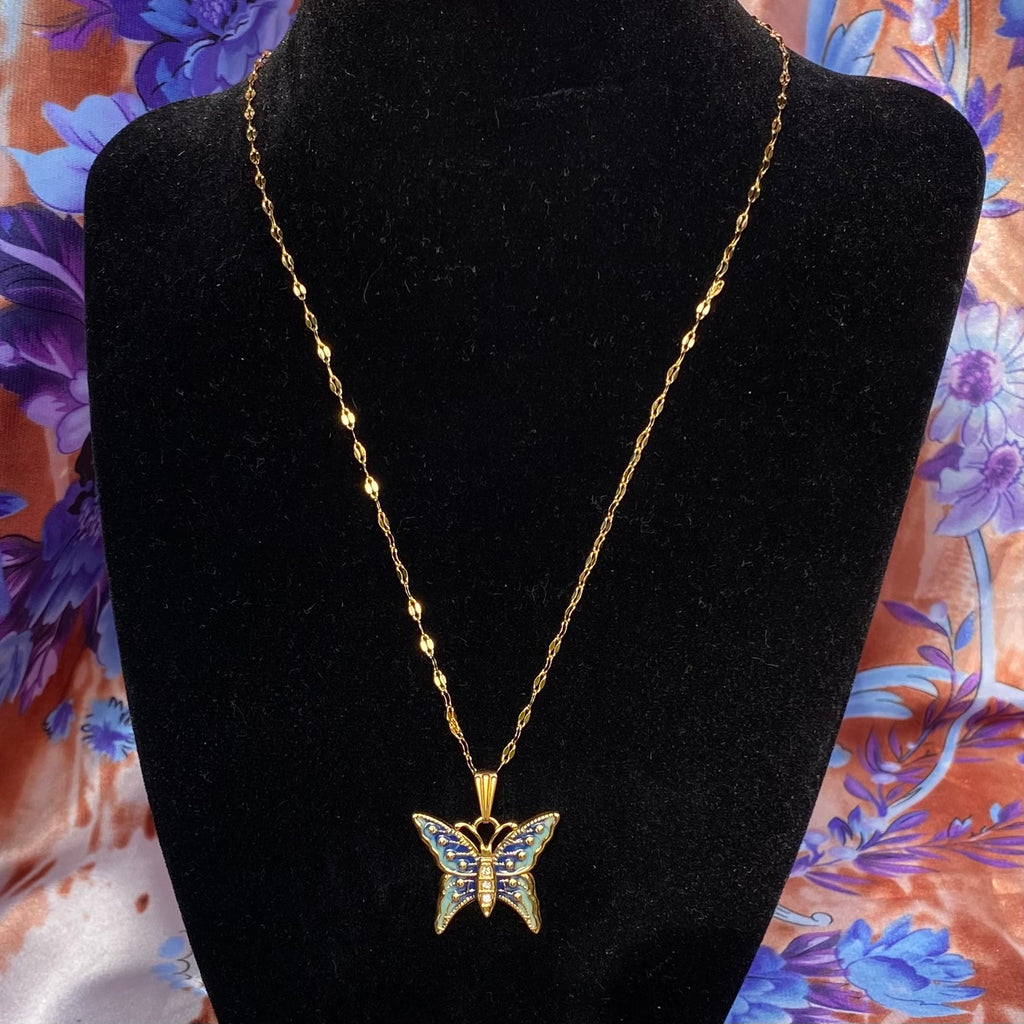 Gold necklace chain with a blue butterfly pendant